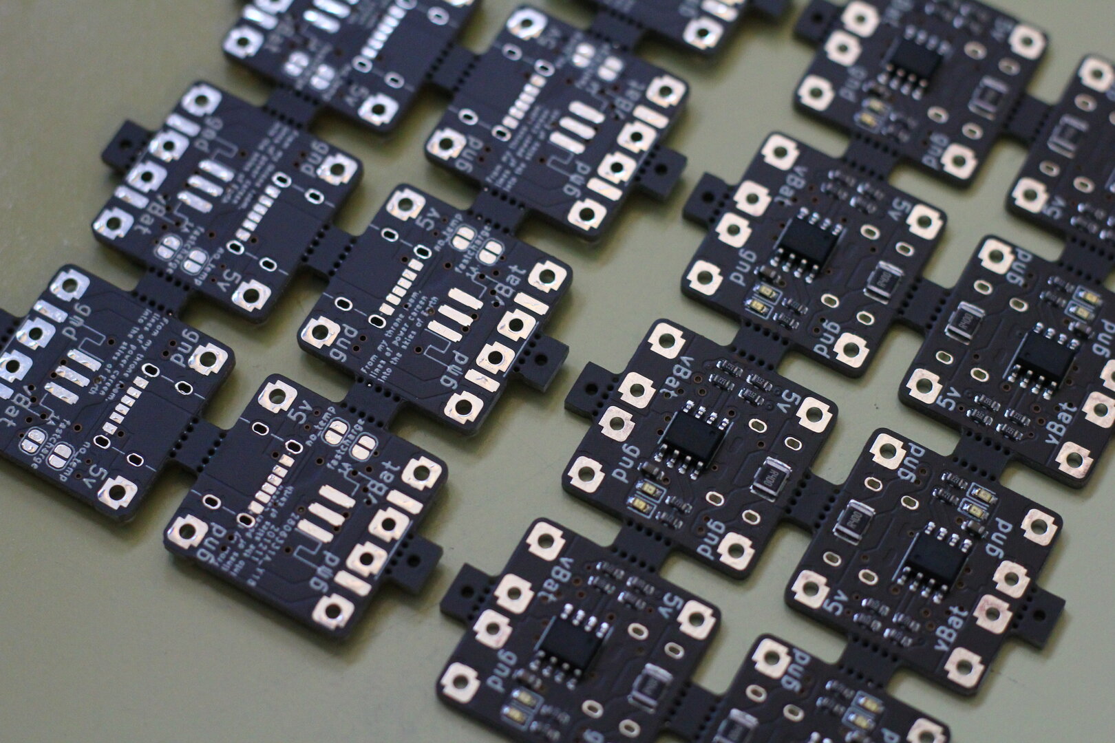 Assembled LiPo Charging PCB's, still in panels of 5x2. On one side is the System Shock Quote “from my throne room, lines of power careen into the skies of Earth”